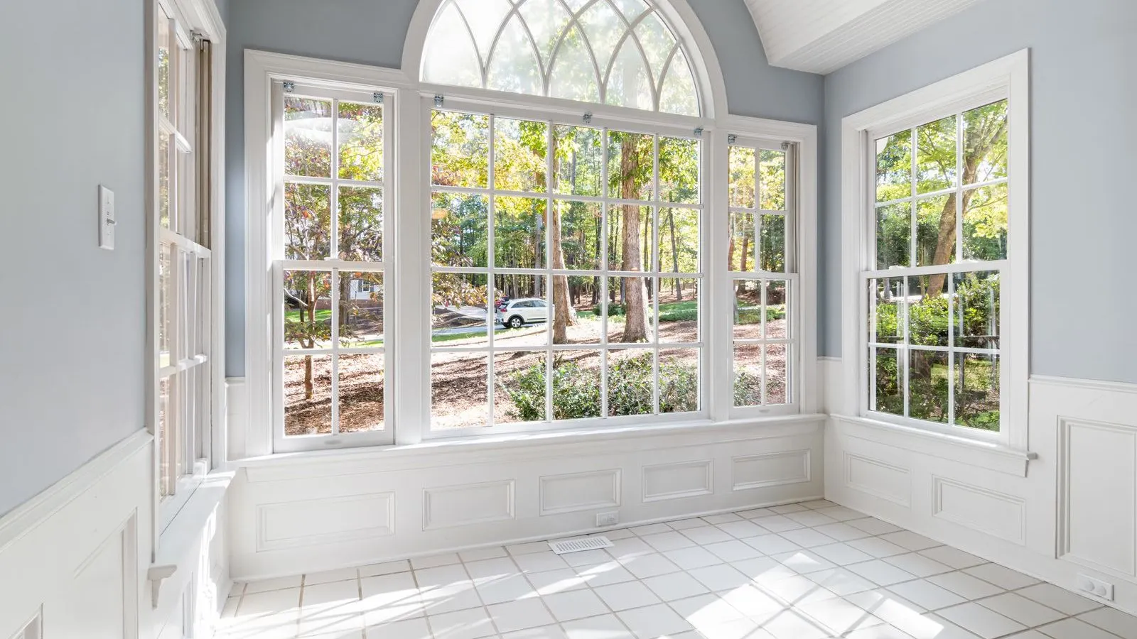 Bright sunlit room with tall energy-efficient residential windows