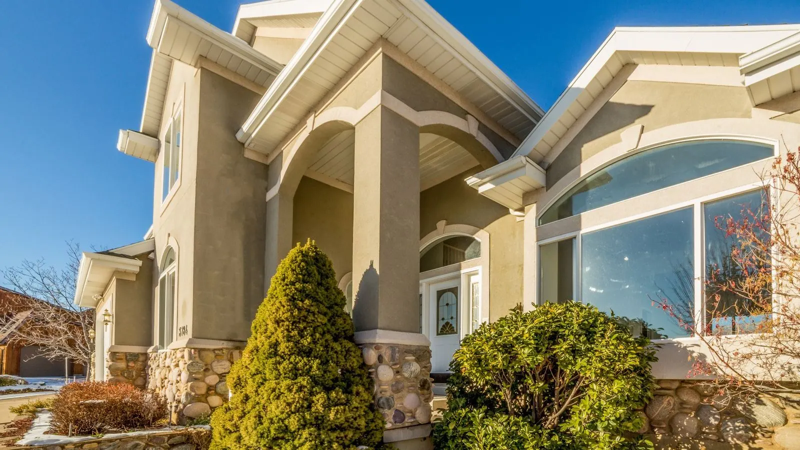 Residential home exterior with white-framed windows